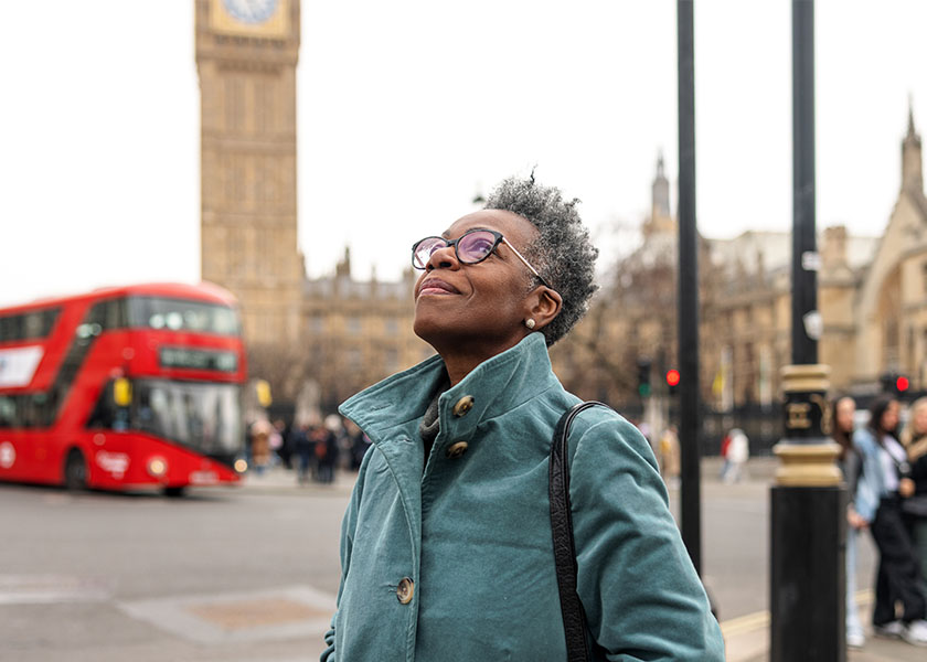 Retiree smiling on a London street. Retiring abroad